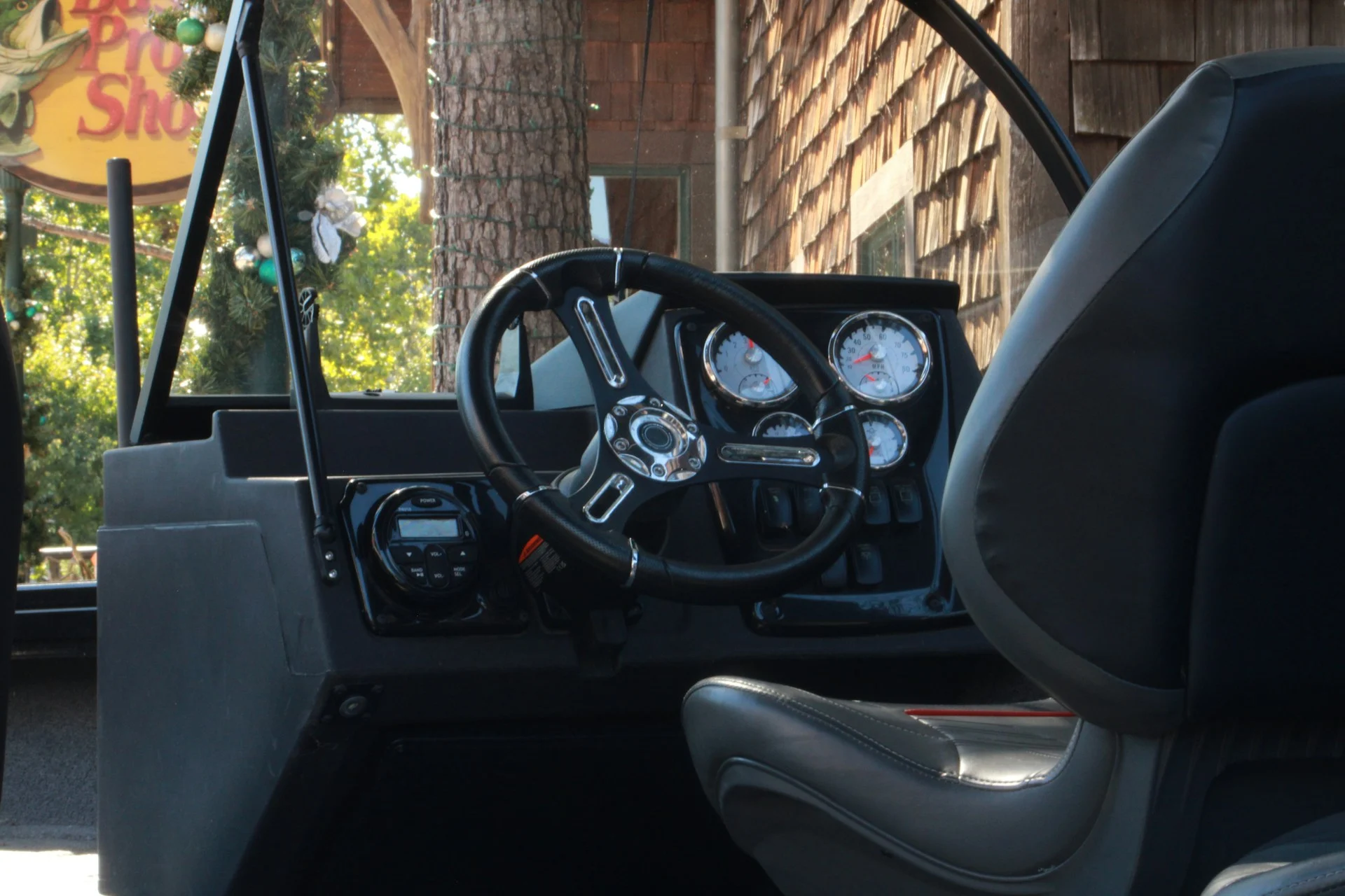 Boat helm and dashboard with gauges and steering wheel