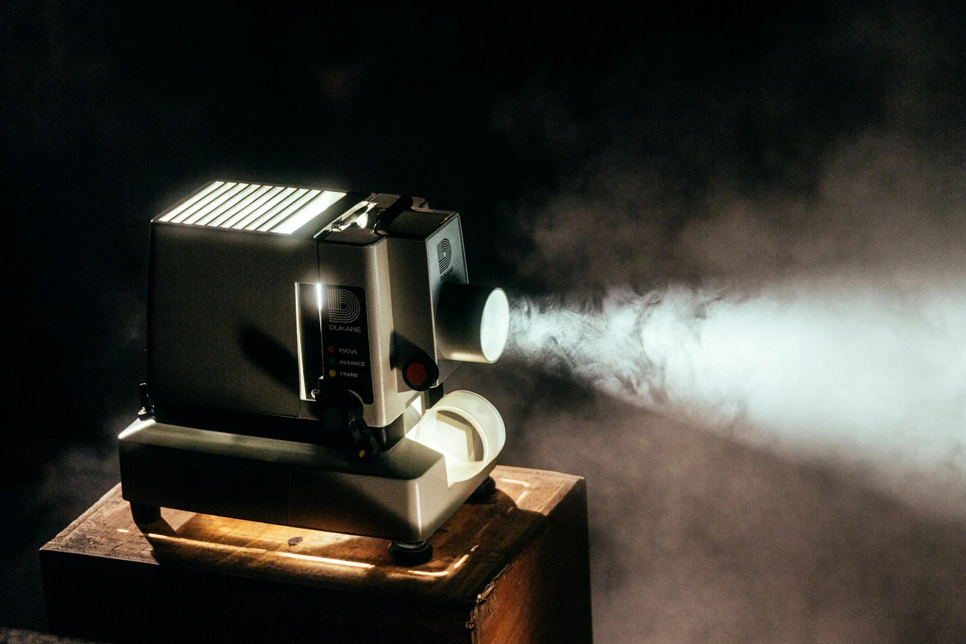 Vintage film projector casting a beam of light