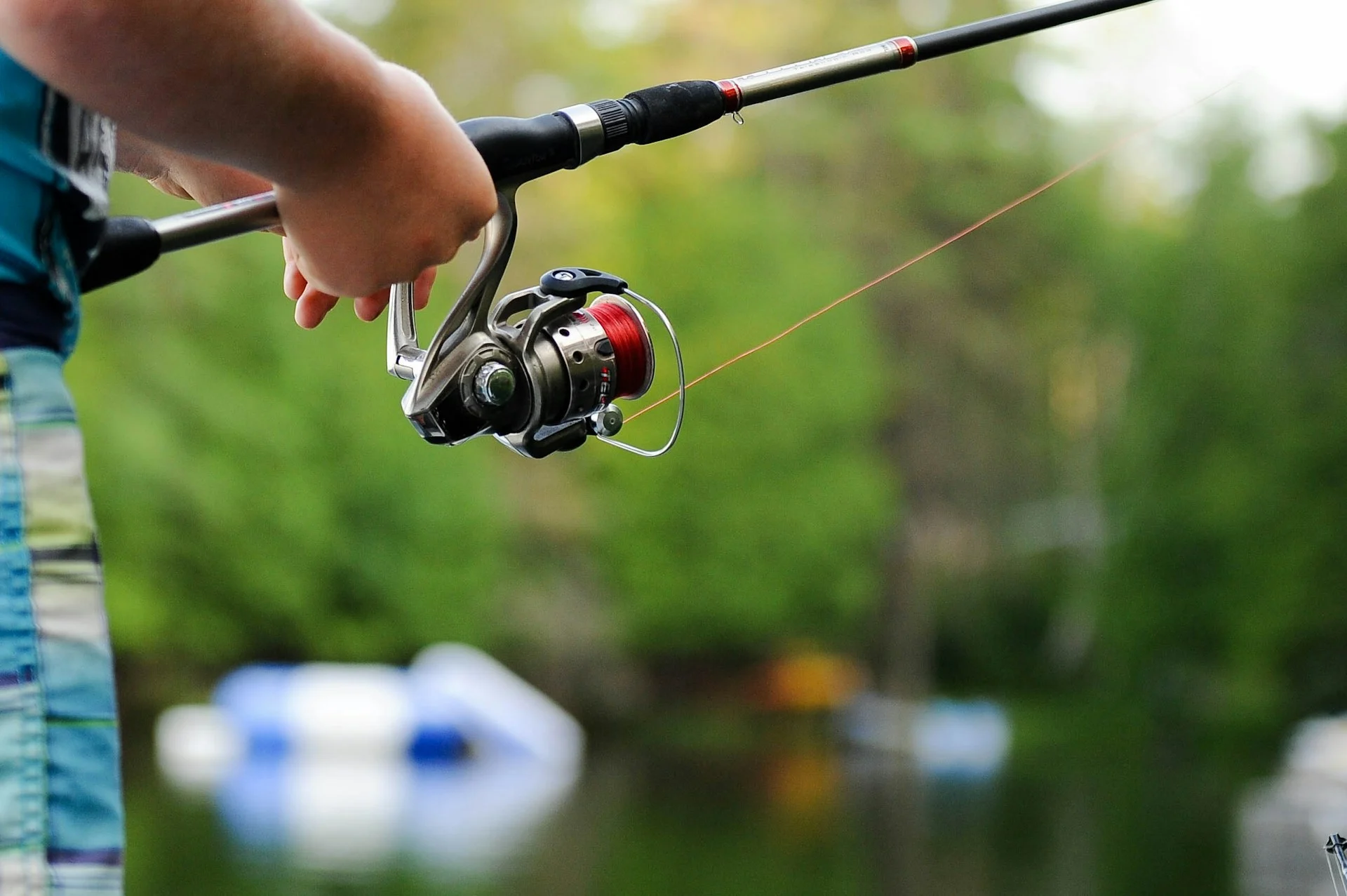 Person holding fishing reel