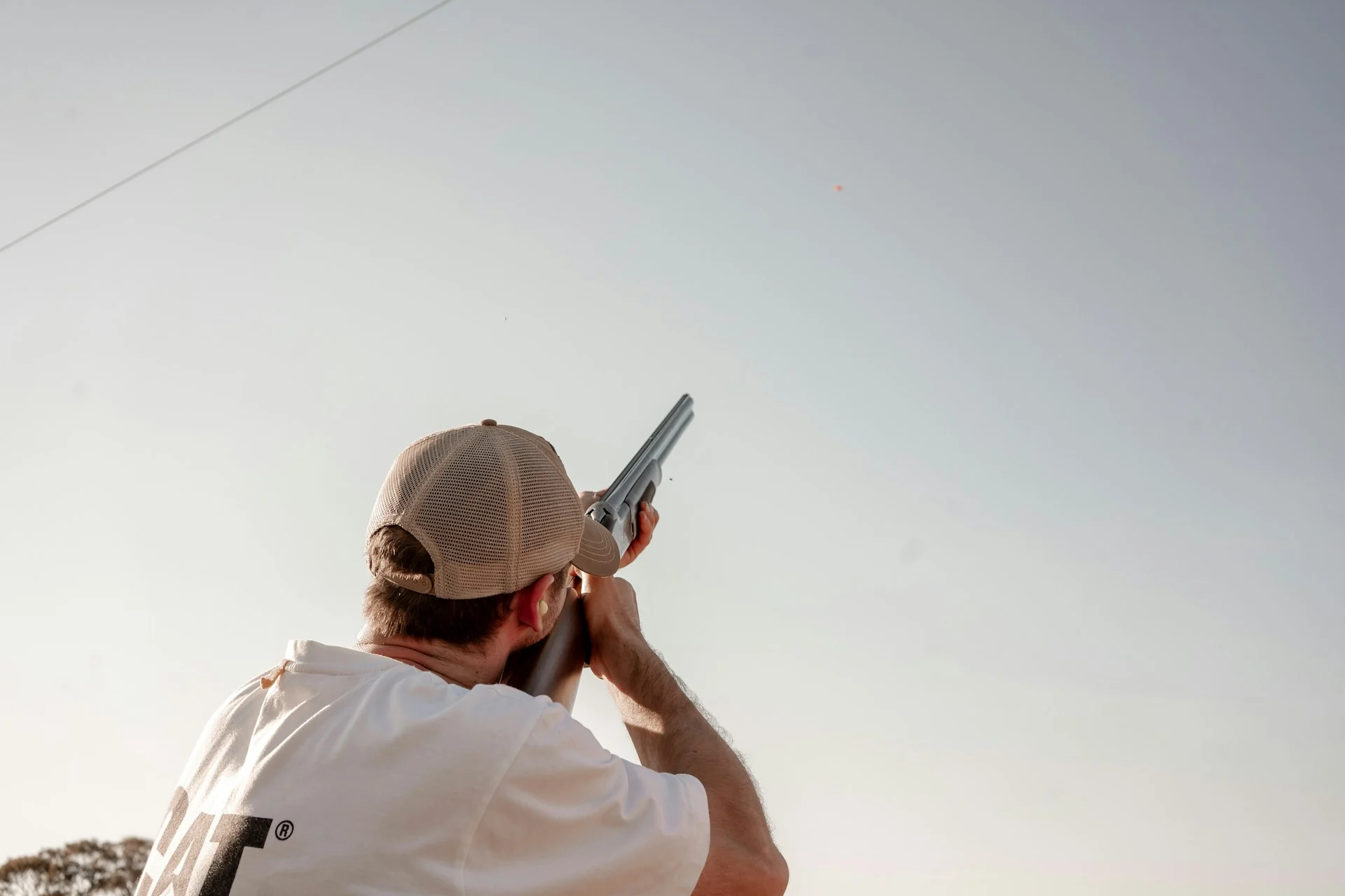 Shooter firing a shotgun toward the sky
